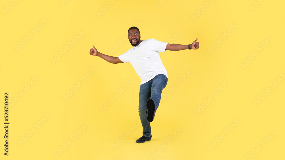 African American Guy Gesturing Thumbs Up Over Yellow Background, Panorama