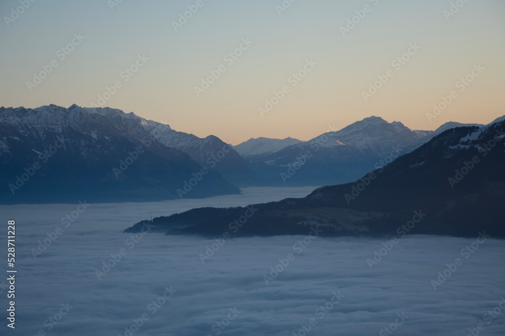 beautiful mountain view at sunset and calming sea of fog