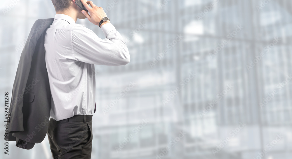 businessman works on smartphone at the office - People isolated on modern office background businessman works on smartphone at the office - People isolated on modern office background