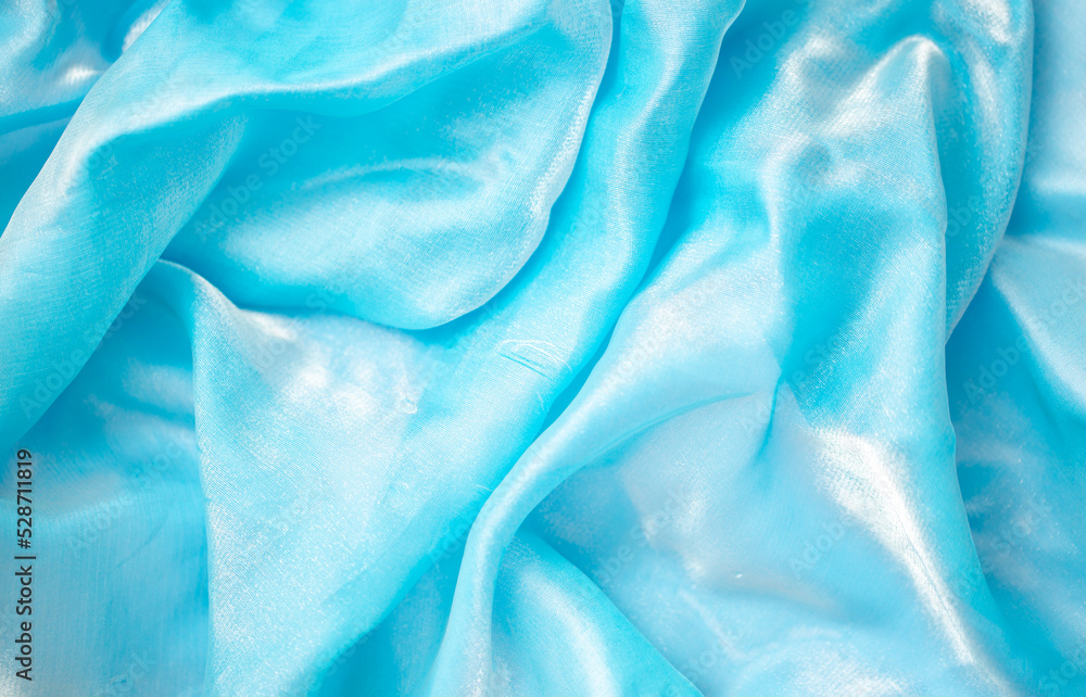 Satin fabric close up background and texture with place for text. Light blue chiffon or silk material. blurred background. blurred background, out of focus Satin fabric close up background and texture with place for text. Light blue chiffon or silk material. blurred background. blurred background, out of focus