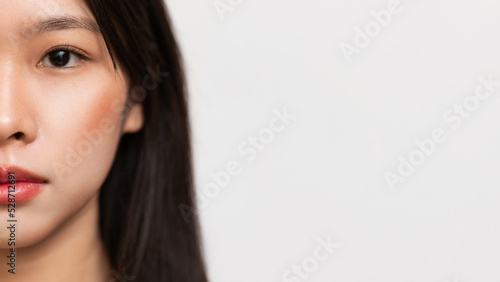 Half face portrait of korean lady with glow skin and natural makeup posing at camera, panorama, copy space