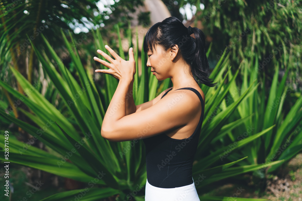 Asian girl practicing yoga and meditating outdoor Asian girl practicing yoga and meditating outdoor