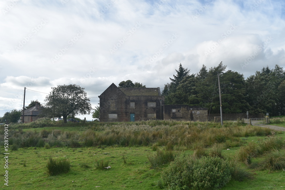 Old abandoned stone building with boarded up windows and doors. Old abandoned stone building with boarded up windows and doors.