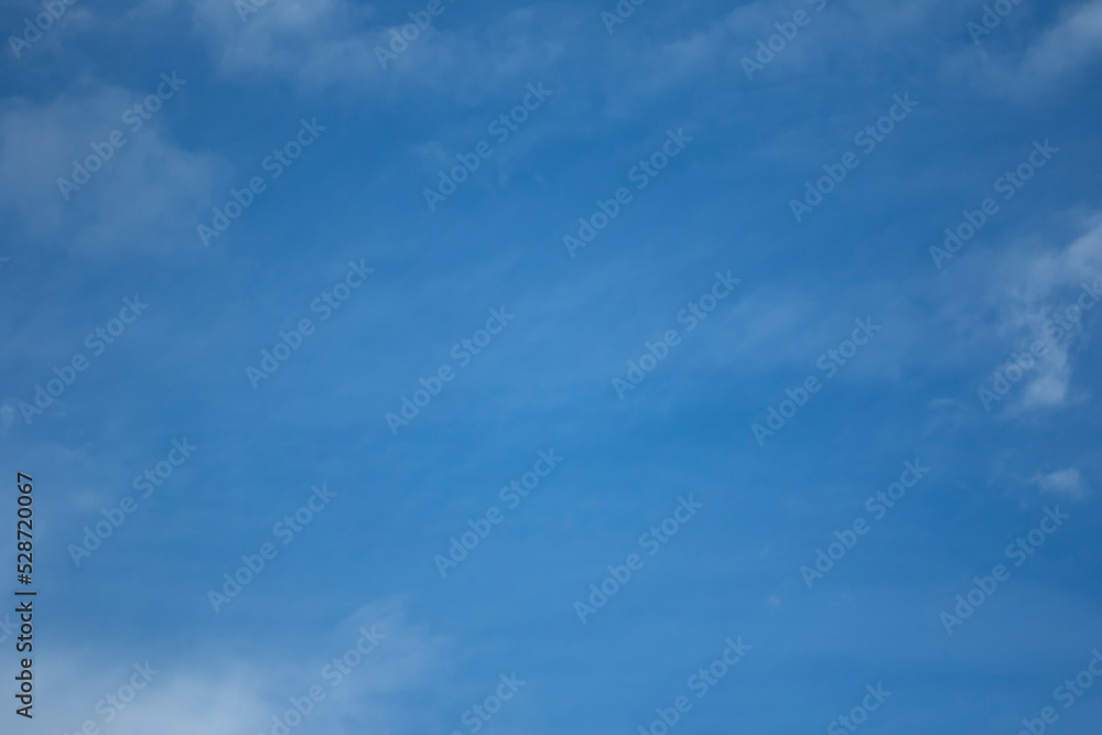 Blue sky with a fluffy white clouds use for background or wallpaper