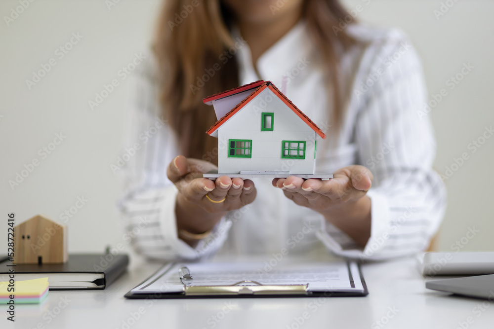 Real estate agents holding model homes are offering and home insurance ideas. Real estate agents holding model homes are offering and home insurance ideas.