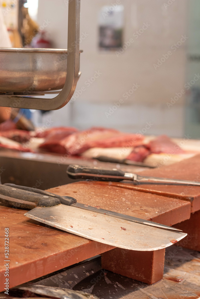 Vertical close up blurred view of fish cutting knife at fish market place Vertical close up blurred view of fish cutting knife at fish market place