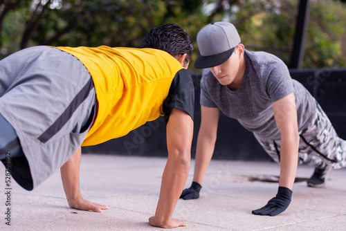 Two athletic men doing exercise together