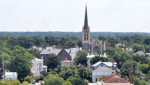 Church with steeple rises about urban neighborhood