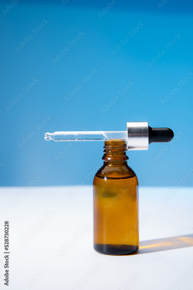 bottle essential oil on a blue background bottle essential oil on a blue background