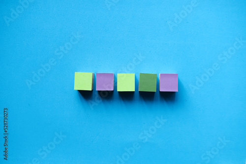 Colorful wooden blocks isolated on a light blue background