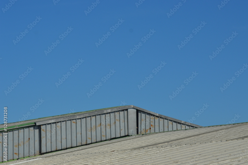 roof of a factory with blue sky