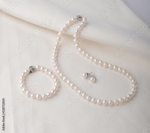 Set of pearl jewelry display on white cloth