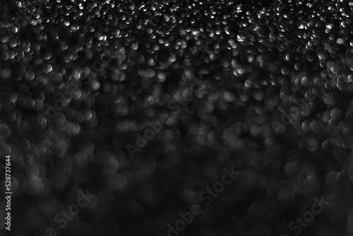 Gray black sparkling glitter bokeh background, christmas abstract defocused texture. Holiday lights. Snowy shiny sparkle stars for celebrate