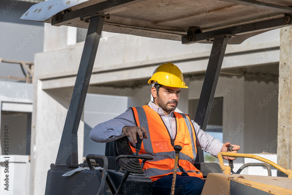 Construction worker are driving grader tractor or construction machine ...