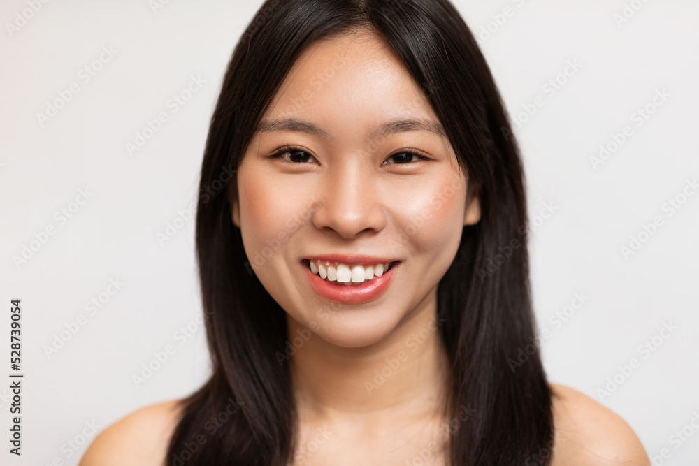 Natural beauty. Portrait of happy korean lady with natural makeup and healthy smooth skin posing on white background Natural beauty. Portrait of happy korean lady with natural makeup and healthy smooth skin posing on white background