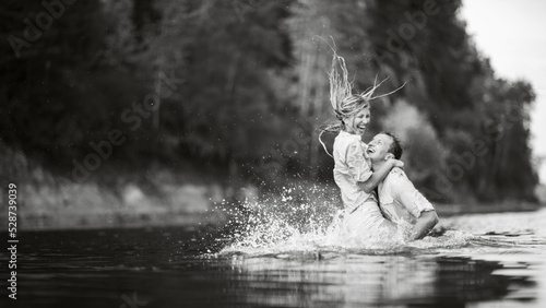 Guy and girl kiss standing in the water.