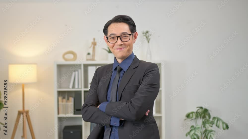 Young, handsome and friendly face man smile with happy and self-confident positive expression with crossed arms on office background. Young, handsome and friendly face man smile with happy and self-confident positive expression with crossed arms on office background.