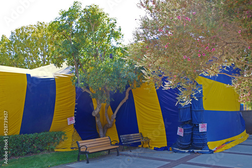 Building covered in a yellow and blue tent for fumigation photo