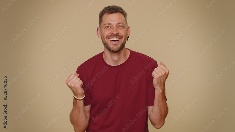 Oh my God, Wow. Excited amazed man looking surprised at camera with big eyes, shocked by sudden victory game winning, lottery goal achievemen, good news. Adult guy on beige studio background indoor Oh my God, Wow. Excited amazed man looking surprised at camera with big eyes, shocked by sudden victory game winning, lottery goal achievemen, good news. Adult guy on beige studio background indoor