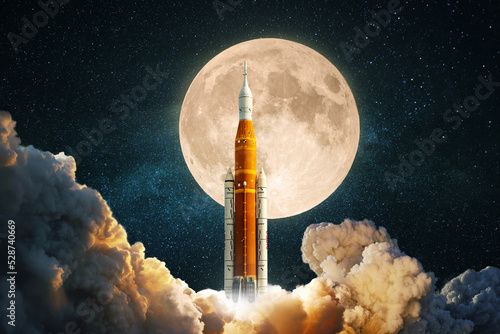 New space rocket is preparing to take off to the moon. Spacecraft successfully launched. Journey to the moon. Ship lift off into the starry sky photo