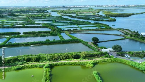 Fish and Oysters farm with aerator pump view from above. Tainan, Taiwan. The growing aquaculture business continuously threatening the nearby Taiwan in East Asia. Ariel View in 4K photo