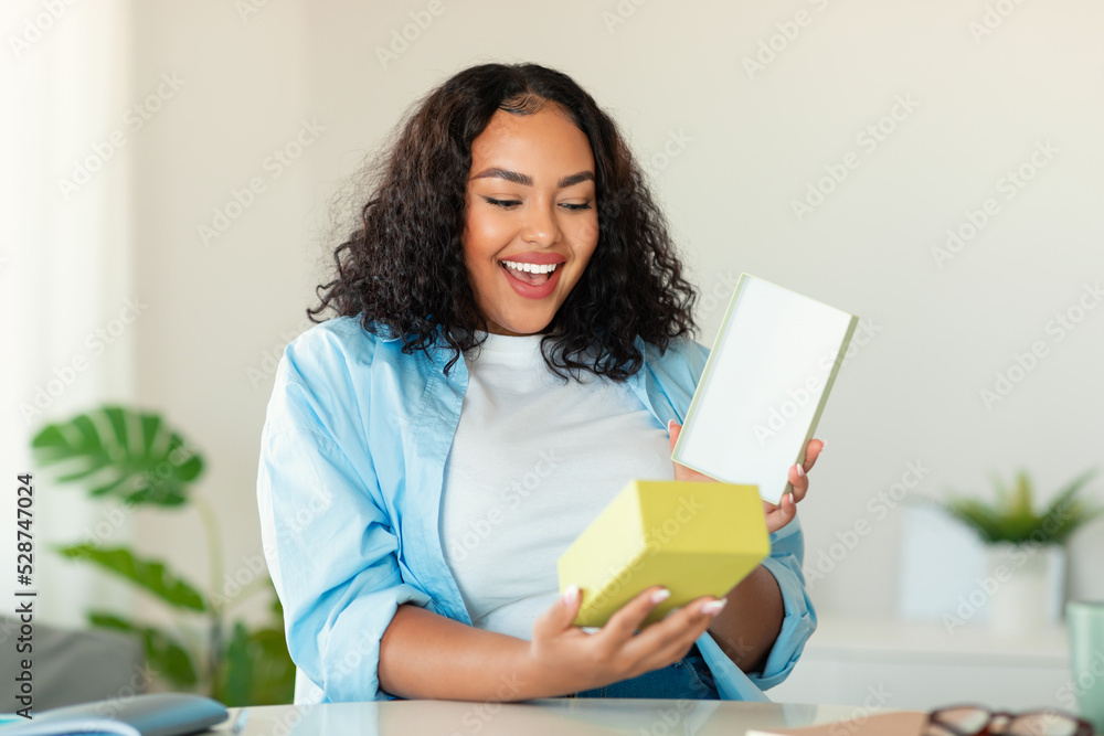 Happy Plus Sized Black Woman Unpacking Delivered Box At Home Happy Plus Sized Black Woman Unpacking Delivered Box At Home