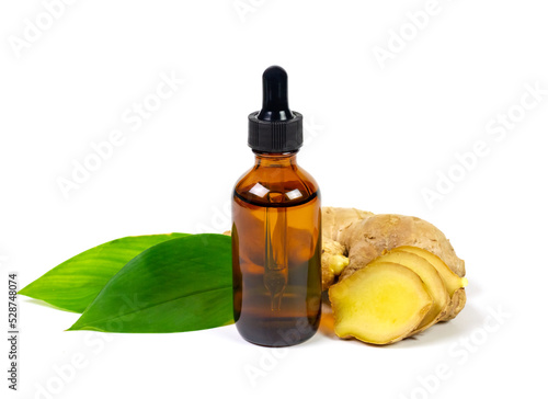 Ginger essential oil in bottle and fresh ginger with green leaf isolated on white background. The scientific name is zingiber officinale. Herbs for health care concept.