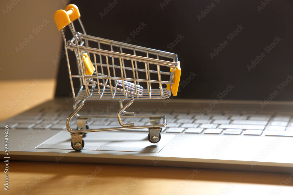 Shopping cart on laptop computer; online shopping concept