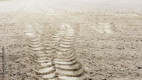 Naturalne tło pożniwnej tekstury gleby z śladem opony traktora. Lato, jesień.