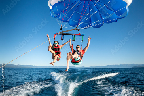 A man and a woman enjoy parasailing in South Lake Tahoe, California. photo