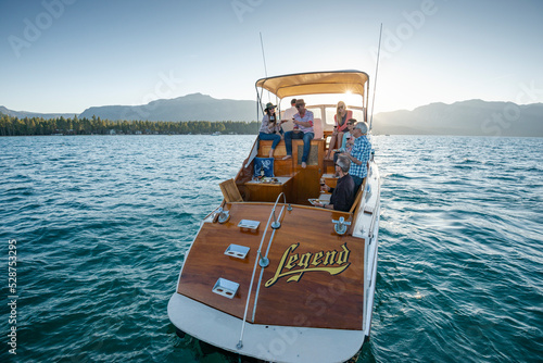 A group of friends cruise on a yacht on a Summer afternoon. photo