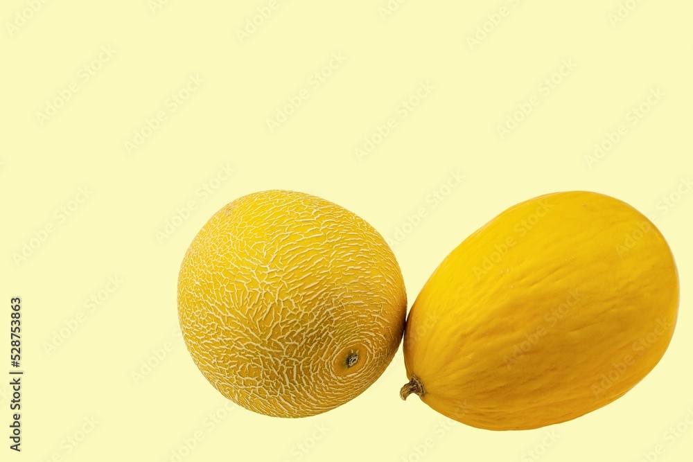 Close up view of melons isolated on yellow background. Close up view of melons isolated on yellow background.