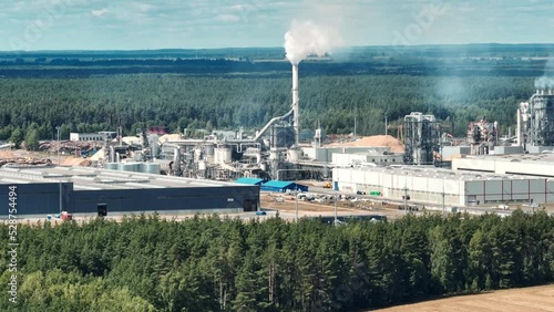 Wallpaper Mural flight over pipes with white smoke of woodworking enterprise plant sawmill. Air pollution concept on industrial landscape Torontodigital.ca