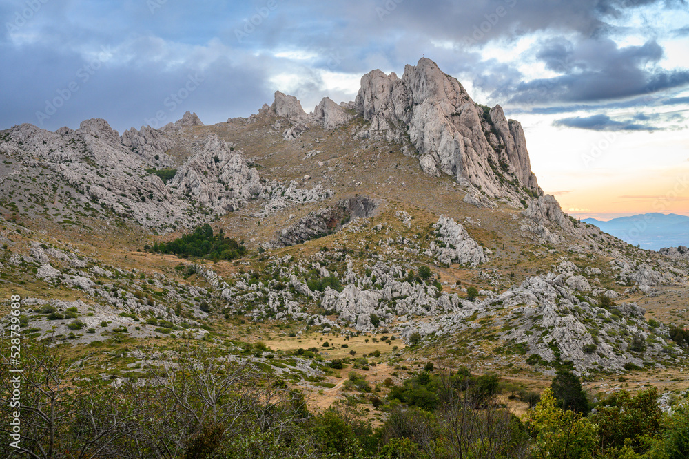 Fototapeta premium Colorful sky from the setting sun over Tulovegrede in the Croatian Velebit mountains.