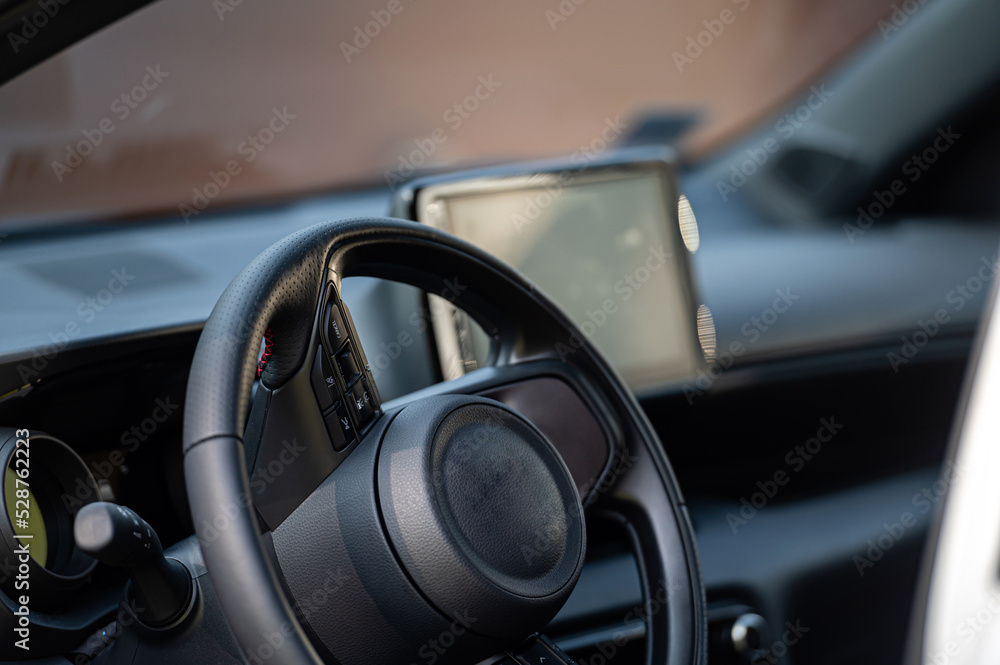 Interior view car with modern steering wheel, dashboard. Closeup. Shallow depth of field