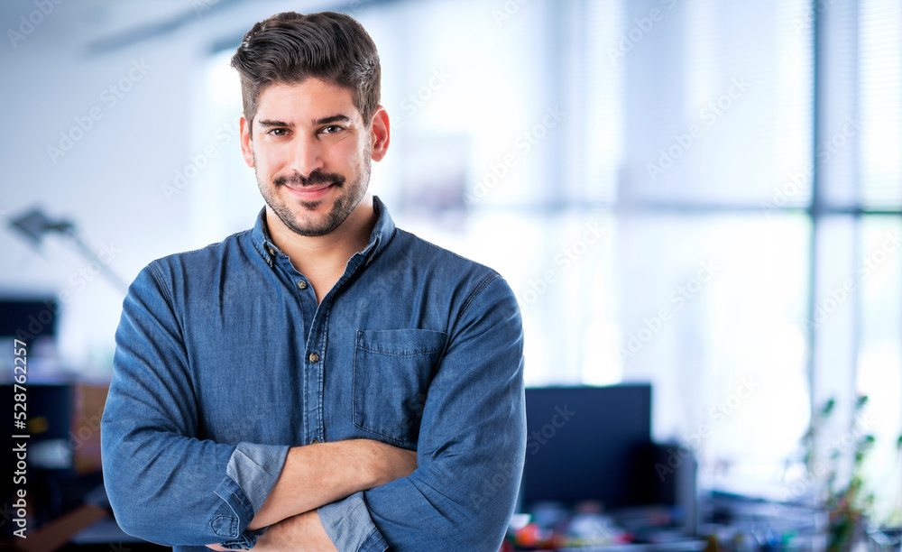 Confident businessman portrait while standing at the office Confident businessman portrait while standing at the office