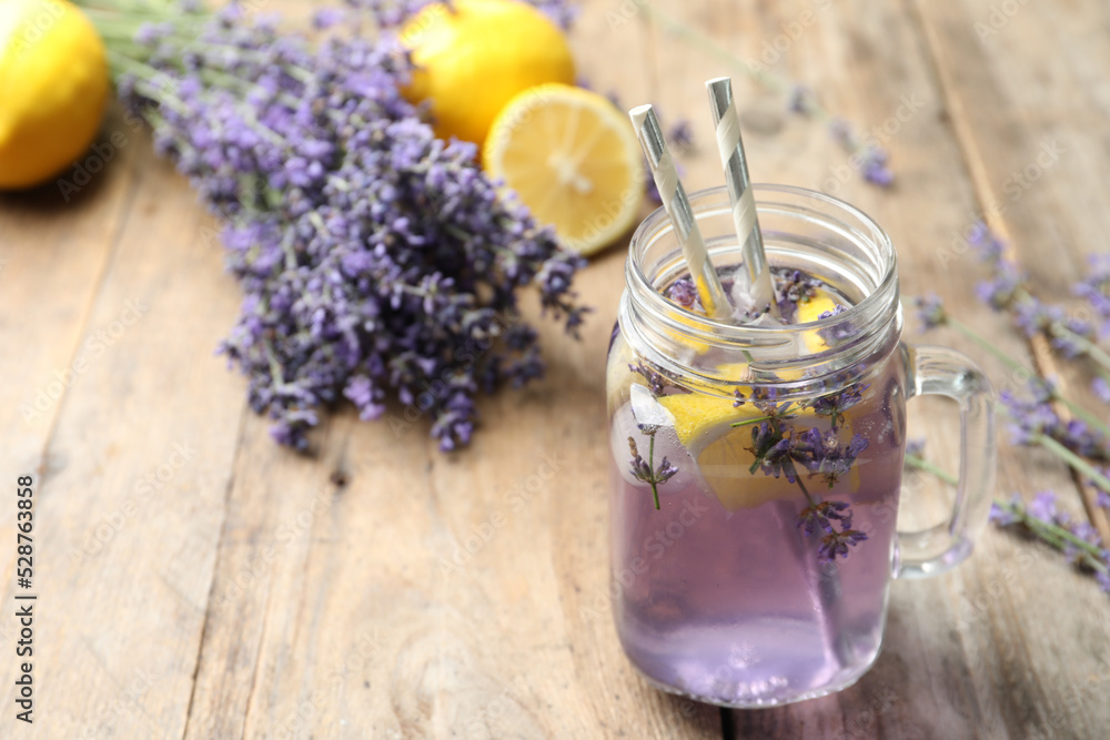 Fresh delicious lemonade with lavender in masson jar on wooden table. Space for text Fresh delicious lemonade with lavender in masson jar on wooden table. Space for text
