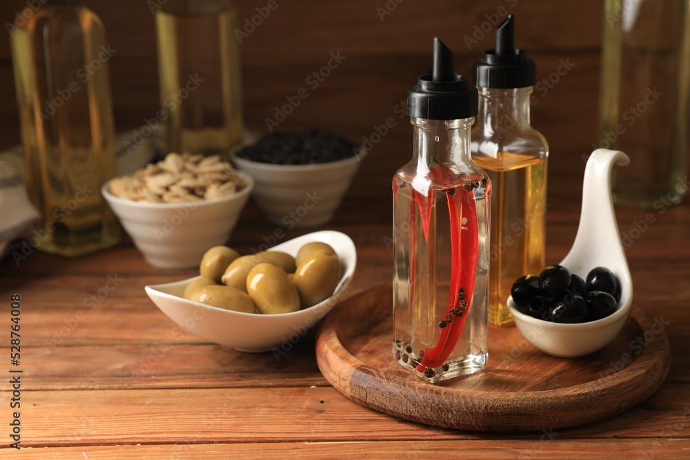 Different cooking oils and ingredients on wooden table Different cooking oils and ingredients on wooden table