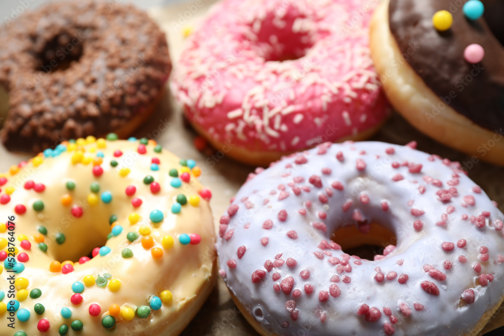 Sweet delicious glazed donuts on table, closeup Sweet delicious glazed donuts on table, closeup