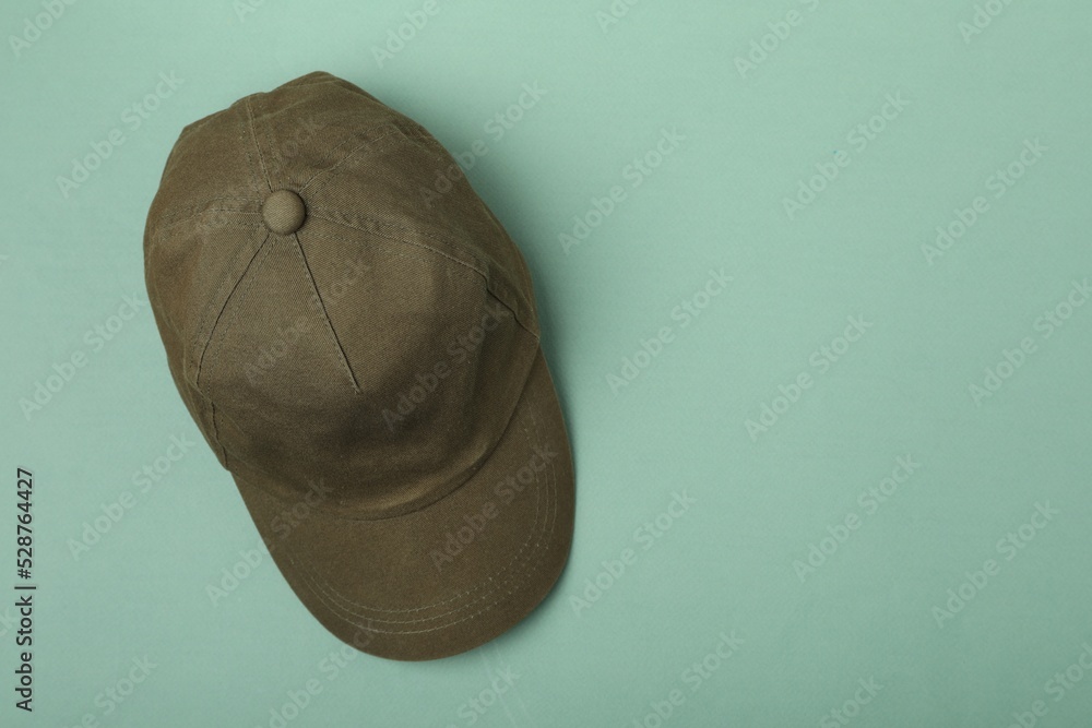 Baseball cap on light green background, top view. Space for text Baseball cap on light green background, top view. Space for text
