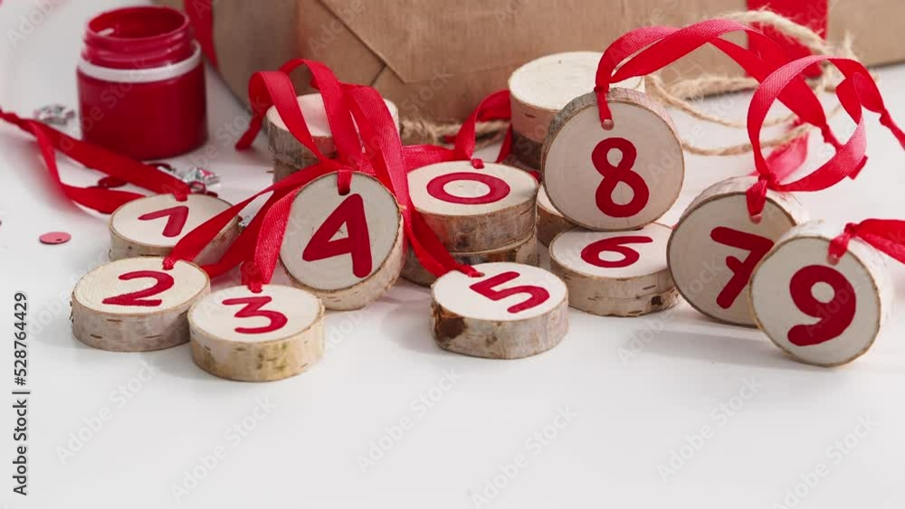 A set of natural, eco-friendly Christmas toys made of wood, made by hand. Red numbers are written on the advent calendar. New Year's decor for a festive tree. New Year and Merry Christmas concept. A set of natural, eco-friendly Christmas toys made of wood, made by hand. Red numbers are written on the advent calendar. New Year's decor for a festive tree. New Year and Merry Christmas concept.