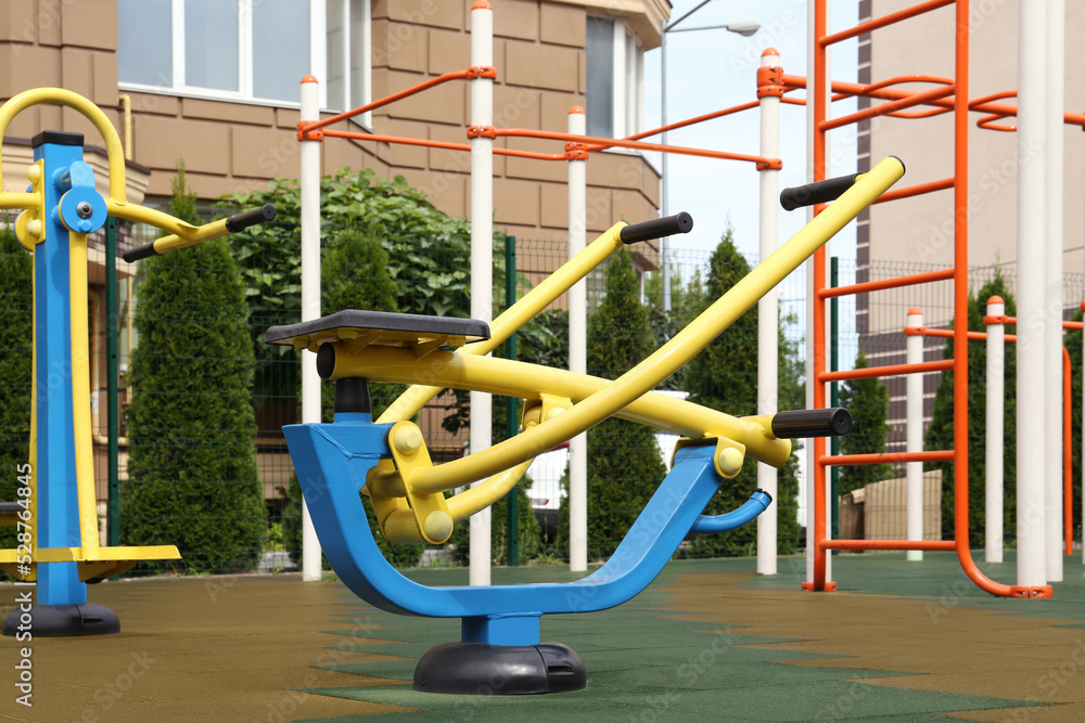 Empty outdoor playground with exercise equipment in residential area