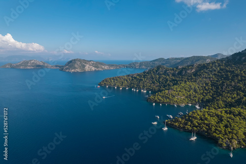 sarsala beach bay dalaman Mediterranean bay with hills and pine forest blue water and boats