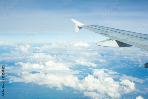 Airplane Window View with Airplane wing and Blue Sky
