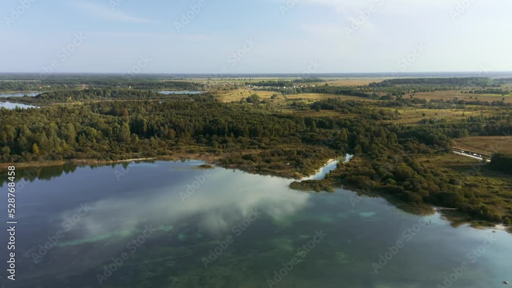 Green lake with bright blue water and distant land aerial panoramic view Green lake with bright blue water and distant land aerial panoramic view