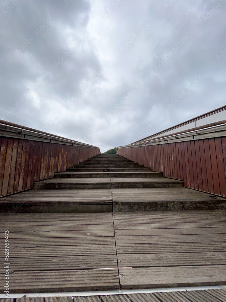modern wooden stairs on a cloudy day in bilbao modern wooden stairs on a cloudy day in bilbao