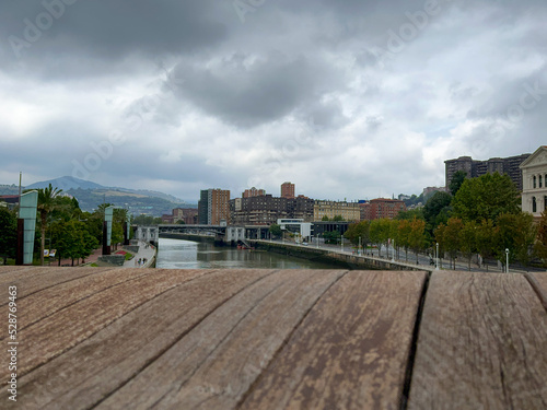 view of the immense river of bilbao from the wooden bridge on a cloudy day