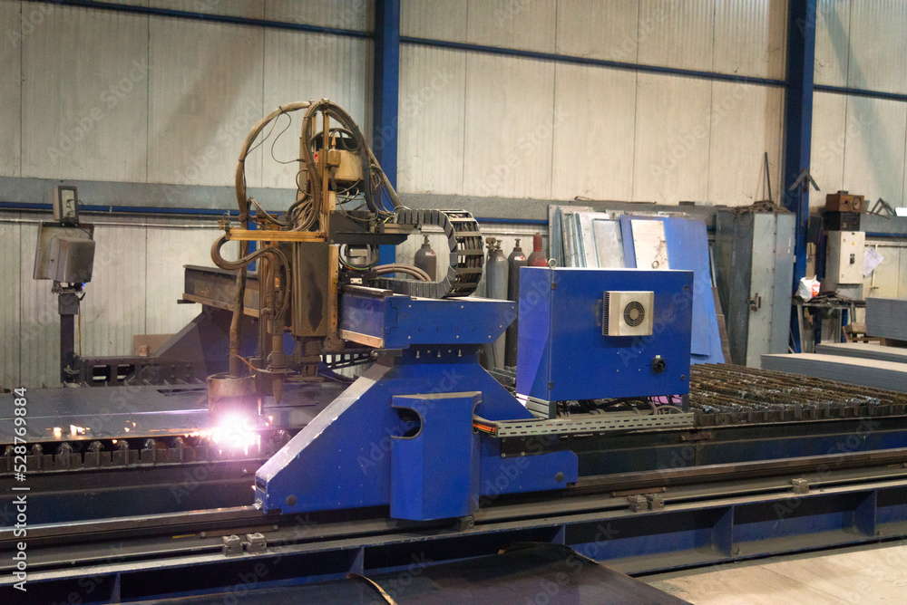 Plasma cutter cutting steel plates in modern construction factory Stock