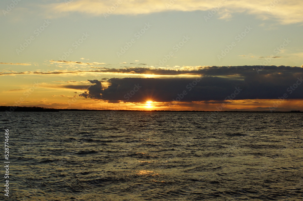 Naklejka premium sunset over the river 