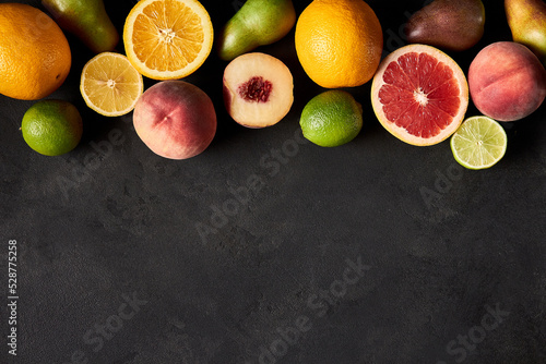 Fresh ripe fruits. Food concept background. Healthy organic food, diet concept. Top view on black board, copy space.